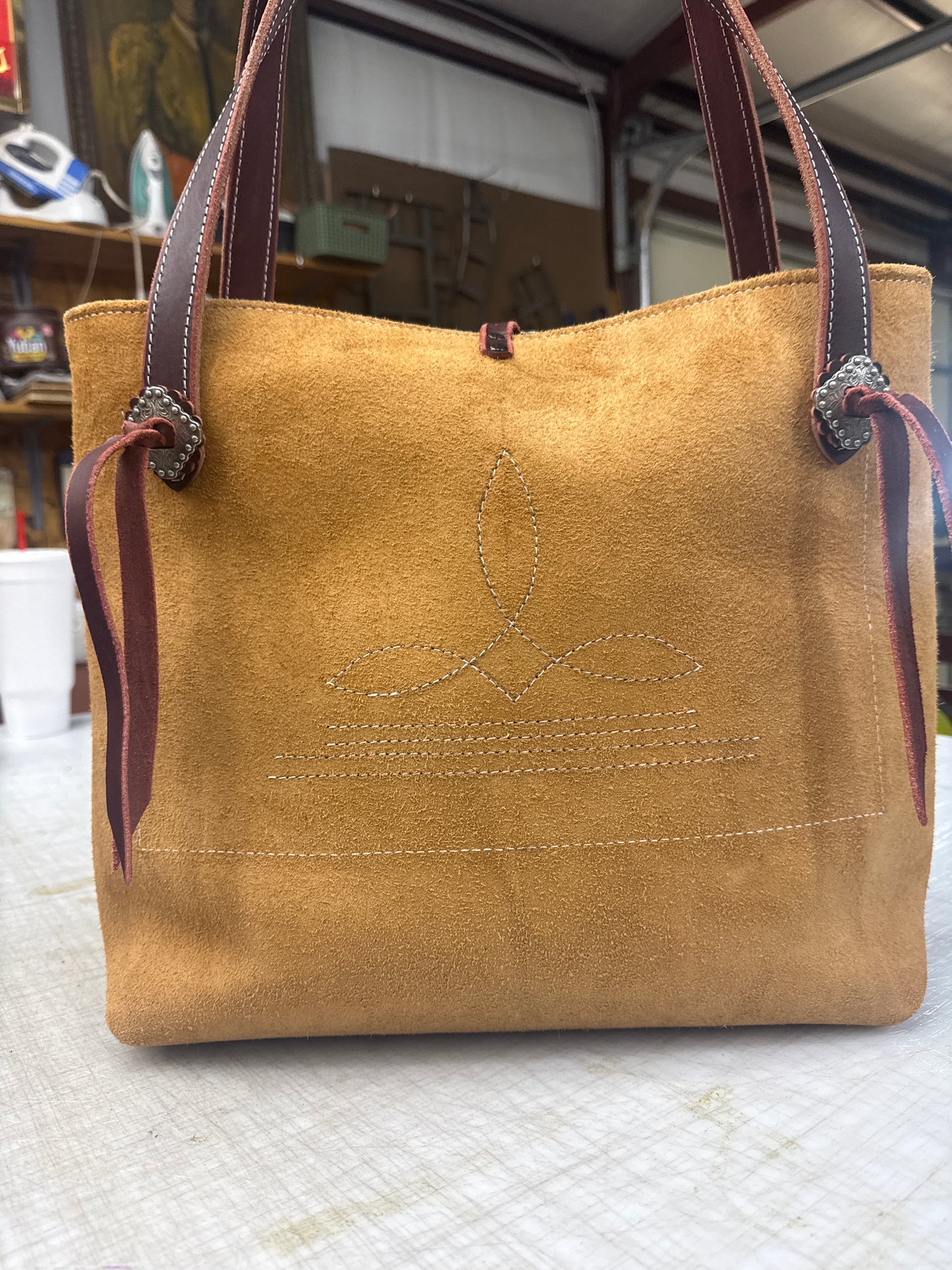 Tan ruff out tote with fancy hardware