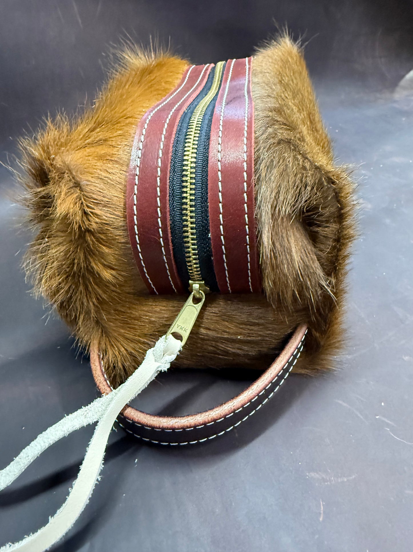 Brown hair on hide bag