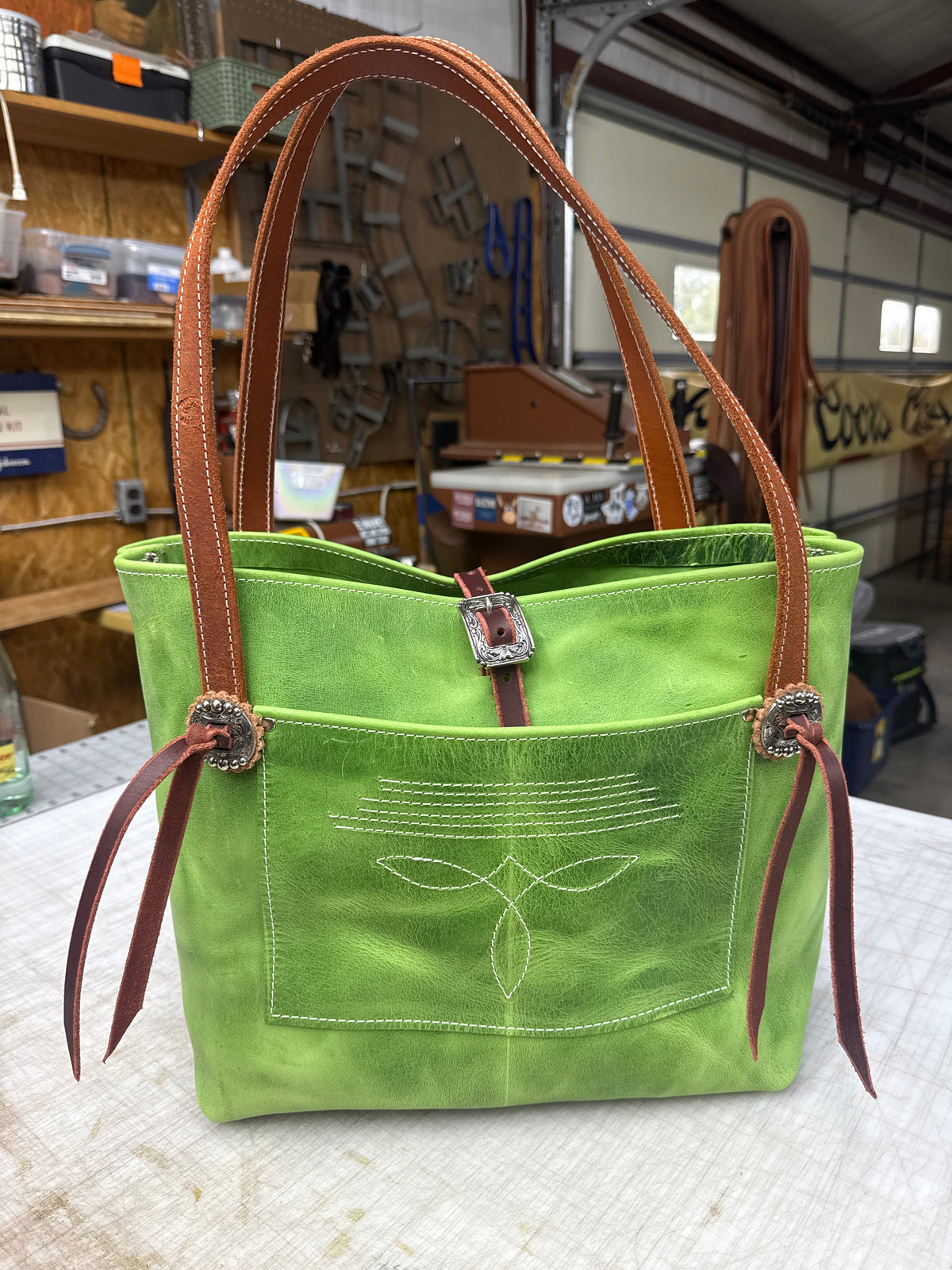 Green tote with fancy hardware