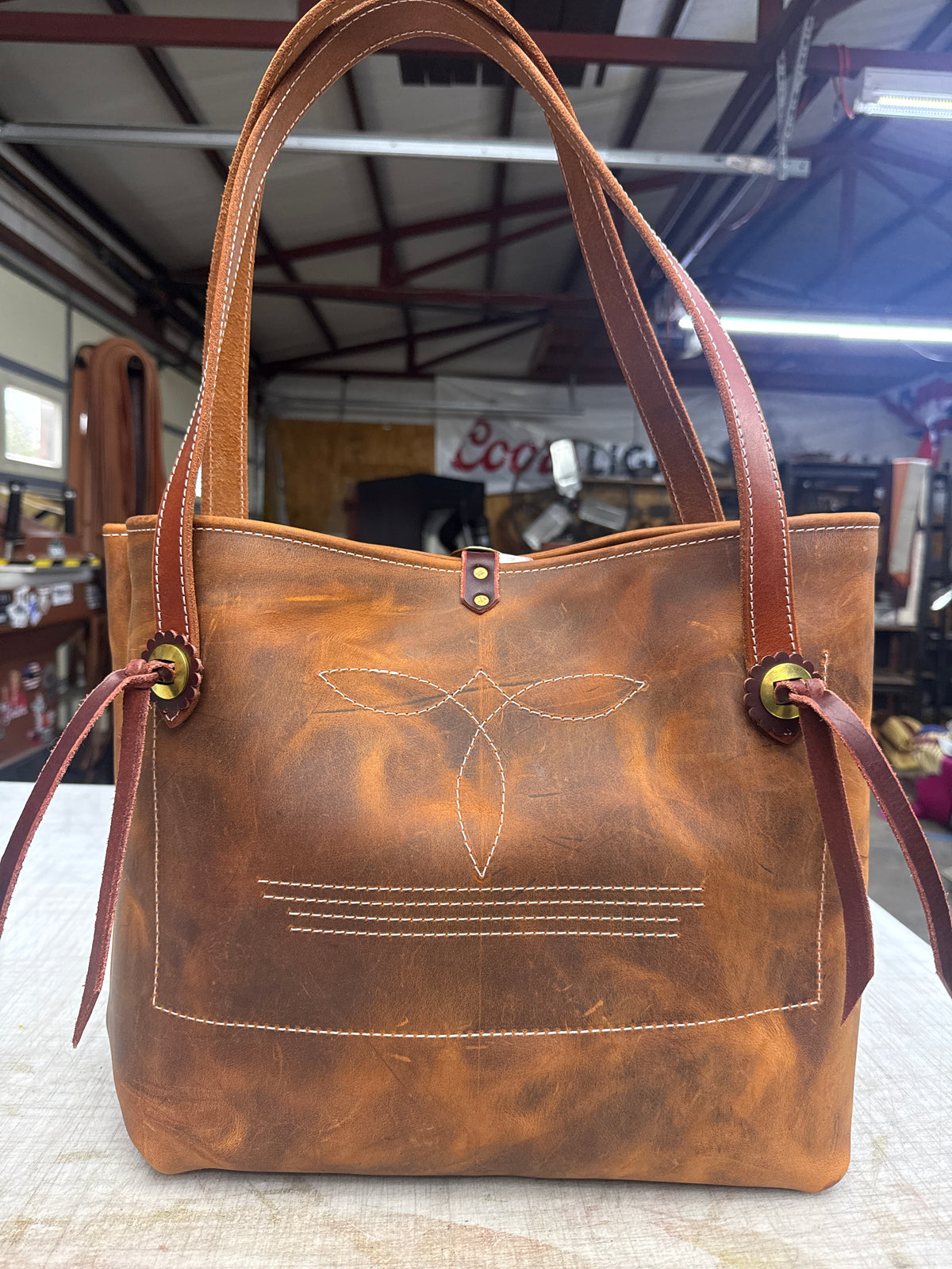 Brown pull up bag with brass hardware